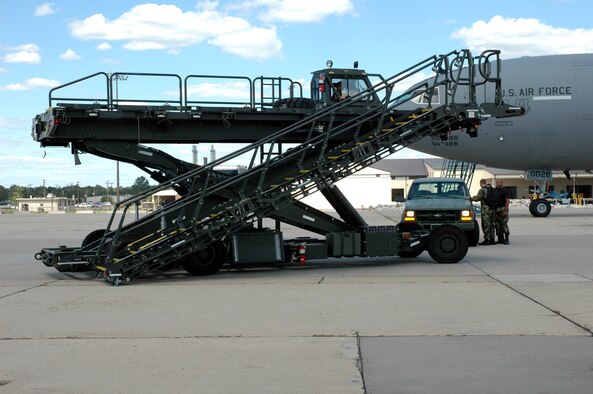 An example of the Halvorson Air Stairs Kit, or HASK, modified cargo loader moves on the flightline at McGuire Air Force Base, N.J., in 2006 during a demonstration of the modified cargo/personnel aircraft loader. The development of the HASK cargo loader came from the Air Mobility Warfare Center's Air Mobility Battlelab. (U.S. Air Force photo)
