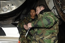 MINOT AIR FORCE BASE, N.D. – Staff Sgt. Justin McNichols (right) and Airman 1st Class Kenny Javar, both from the 5th Aircraft Maintenance Squadron, work on replacing a strut valve on a B-52H Stratofortress located on the flight line Jan.. 8. The crew endured freezing temperatures and gusts of wind up to 50 knots. (U.S. Air Force photo by Airman 1st Class Christopher Boitz)