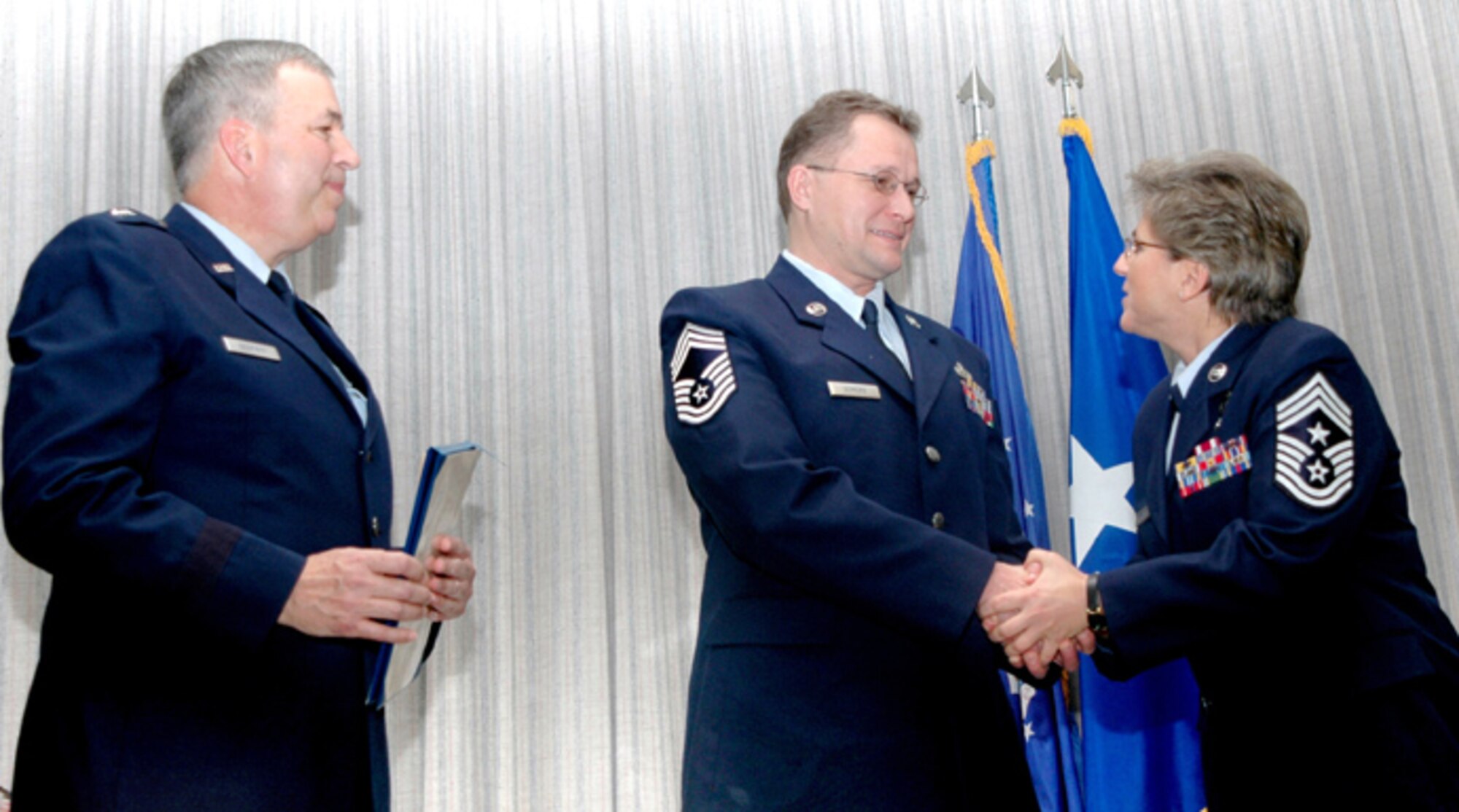GRISSOM AIR RESERVE BASE, Ind.,--Air Force Reservist William Somers of Logansport, Ind.,  is congratulated by Brig. General Dean Despinoy, commander 434th Air Refueling Wing, and Command Chief Master Sgt. Peri Rogowski on his promotion to chief master sergeant during a special recognition ceremony.  (U.S. Air Force photo/Senior Airman Chris Bolen)