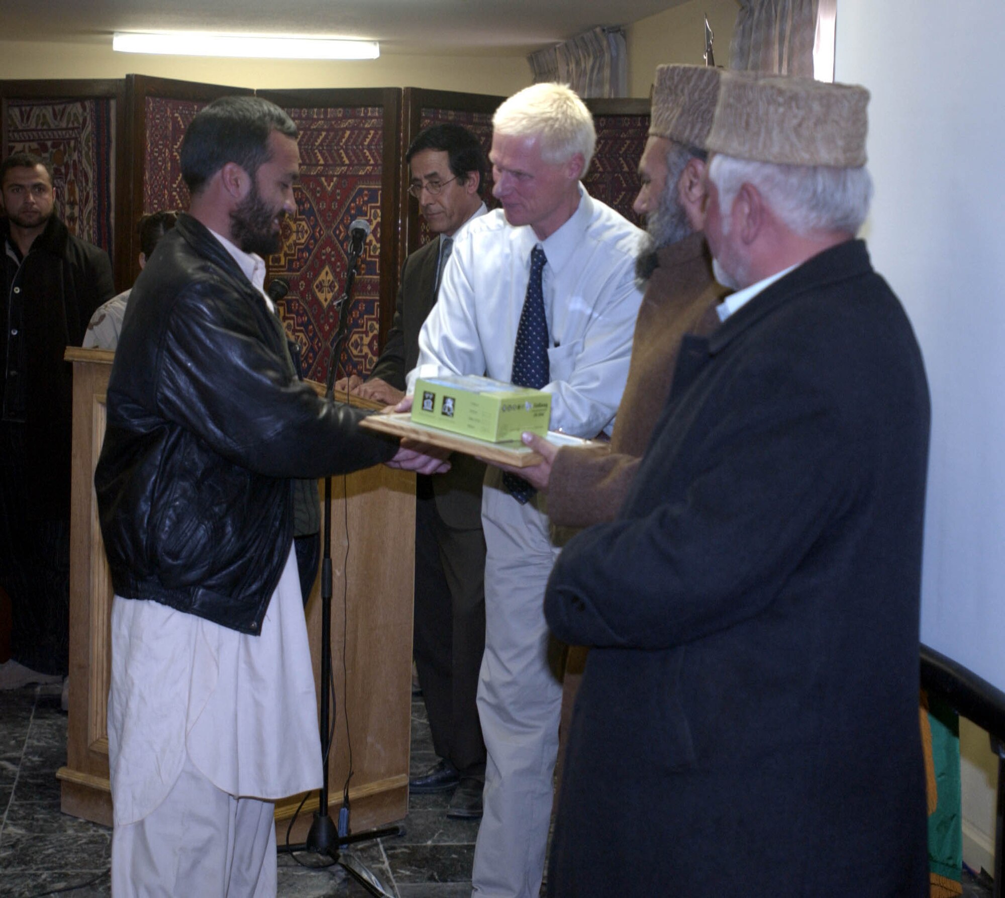 Dr. Mike Gangwer shakes the hand of one of his students during the Comprehensive Agricultural Course for Soils, Crops, Agronomy and Animal Sciences graduation ceremony January 6.  The course was about 20 weeks long and graduated more than 50 students.  Dr. Gangwer is a Department of Agriculture soil scientist assigned to the Bagram Provincial Reconstruction team.  (U.S. Air Force photo/ Senior Airmen J.G. Buzzanowski) 