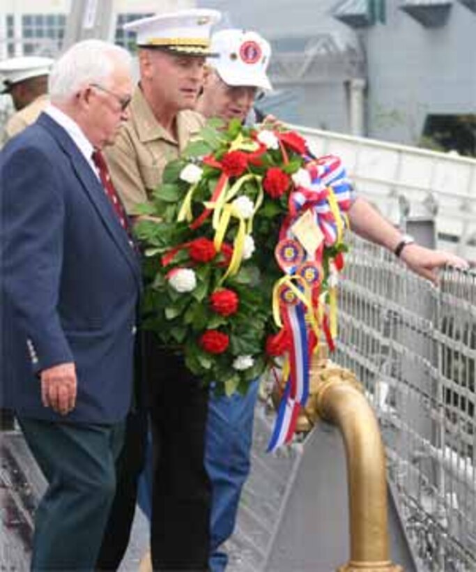 Norfolk, Va. ? Thomas M. Terpinas, a past president of the Sixth Marine Division Association, rings the bell throughout the association?s final roll call during its memorial service here Oct. 10 on the USS Wisconsin.  The ringing of the bell is a symbolic custom at memorial services that signifies fallen comrades.