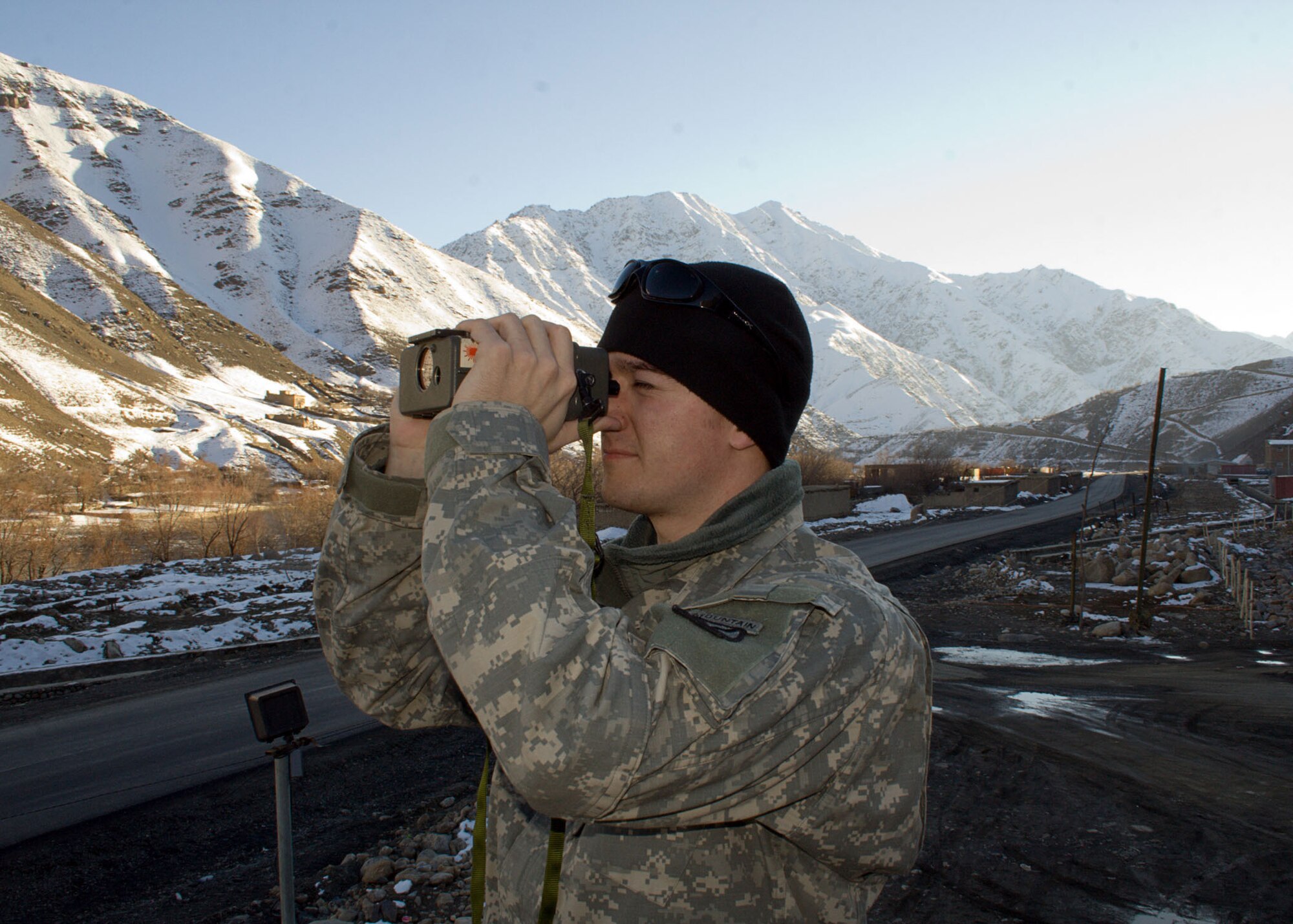 Senior Airman Nathan Fried uses a laser range finder to gather data for visibility charts Jan. 4 in the Panjshir Province in Afghanistan. He spent two days in early January training members of the Panjshir Provincial Reconstruction Team to take weather observations to help make aviation-support and convoy-operations decisions in the Panjshir Province. Airman Fried is assigned to the 20th Expeditionary Air Support and Operations Squadron at Bagram Air Base, Afghanistan. (Courtesy photo/Oref Spanta)
