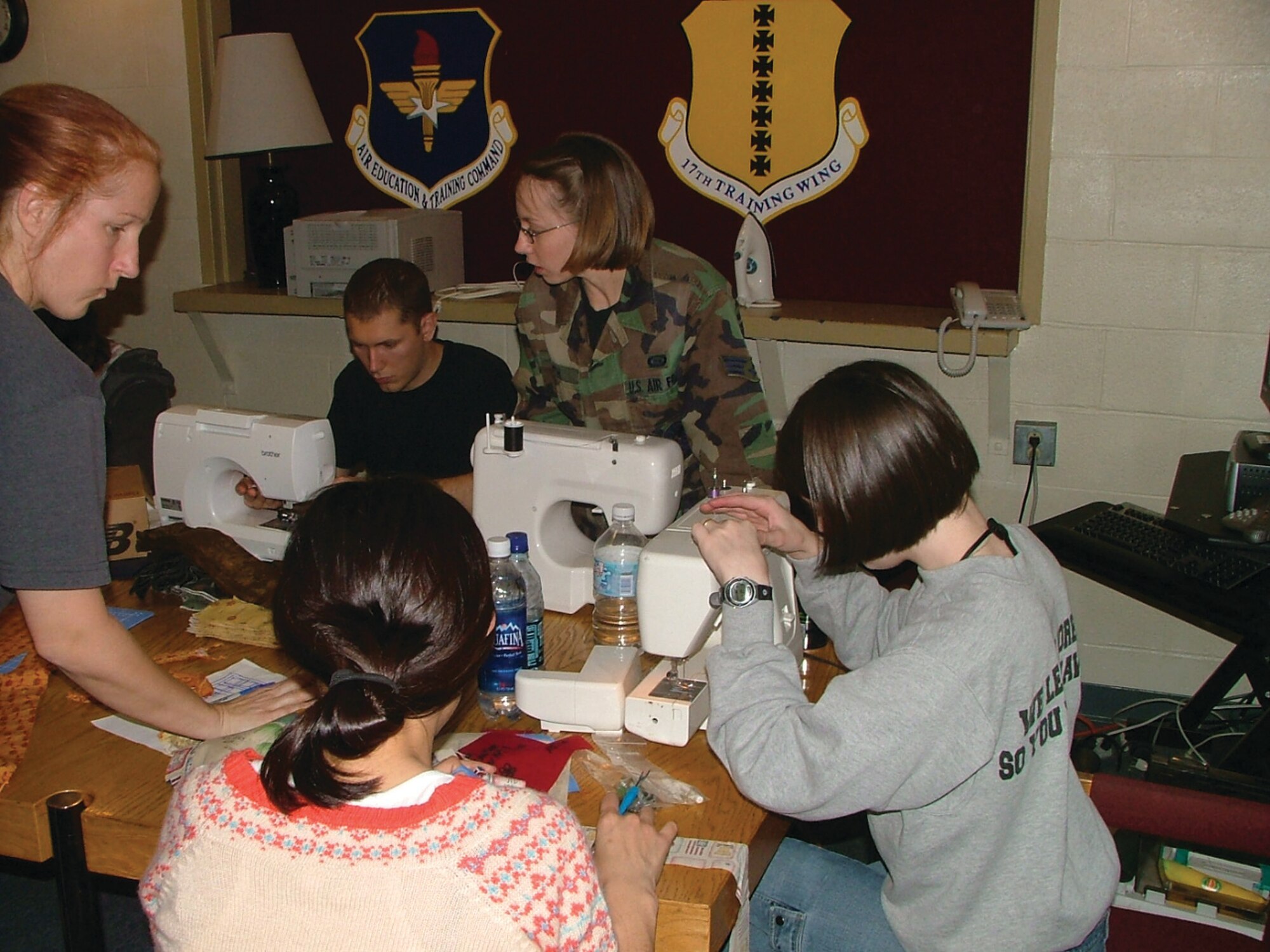 Chief Academic Training Advisor Master Sgt. Susan Boyd led a group of approximately 30 airmen sewing quilts for wounded soldiers and airmen.  311th students and staff members write messages of hope and inspiration on quilt squares for service members wounded in action.