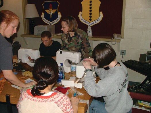 Chief Academic Training Advisor Master Sgt. Susan Boyd led a group of approximately 30 airmen sewing quilts for wounded soldiers and airmen.  311th students and staff members write messages of hope and inspiration on quilt squares for service members wounded in action.