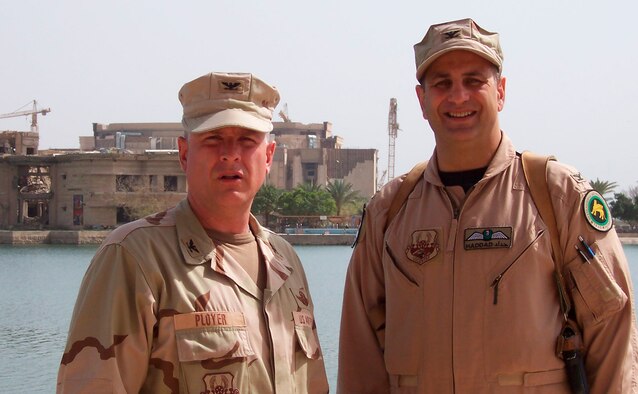 Standing in front of the “Victory Over America” palace that once belonged to Saddam Hussein is Col. Dennis Ployer, 447th Air Expeditionary Group commander, Sather Air Base, Iraq, and 911th Air Wing vice commander, Pittsburgh Air Reserve Station, Penn.; and Col. Richard “Beef” Haddad, Coalition Air Force Transition Team U.S. senior advisor, New Al Muthana Air Base, Iraq, and 403rd vice commander, Keesler Air Force Base, Miss.  While in power, Saddam named his palaces after what he claimed were his victories. This palace is located near the international airport in Baghdad.  (U.S. Air Force photo) 