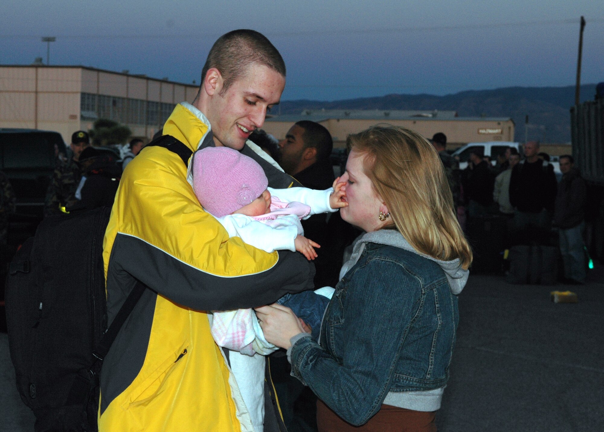 Airman 1st Class Bret Mills, 49th Maintenance Squadron, says goodbye to his wife, Stephanie, and his daughter, Gianna, 8 months, before he deploys to Korea Monday. More than 300 Airmen are going on this deployment from Holloman (U.S. Air Force photo by Airman Jamal Sutter)