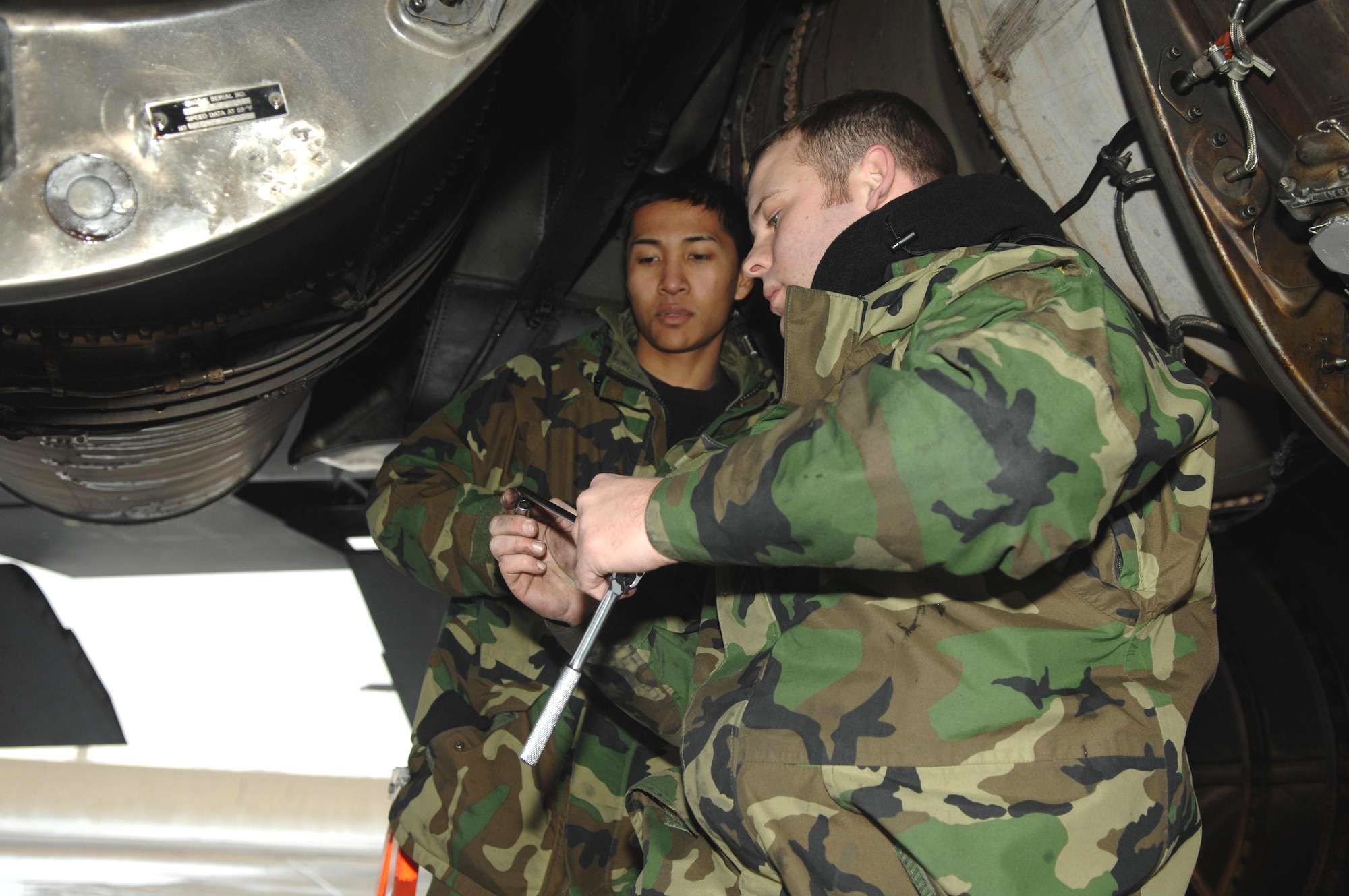 Staff Sgt. Justin McNichols (right) and Airman 1st Class Kenny Javar work on replacing a strut valve on a B-52 Stratofortress Jan. 8 at Minot Air Force Base, N.D. The workers endured sub-zero temperatures and gusts of wind up to 50 mph. Both Airmen are with the 5th Aircraft Maintenance Squadron. (U.S. Air Force photo/Airman 1st Class Christopher Boitz) 