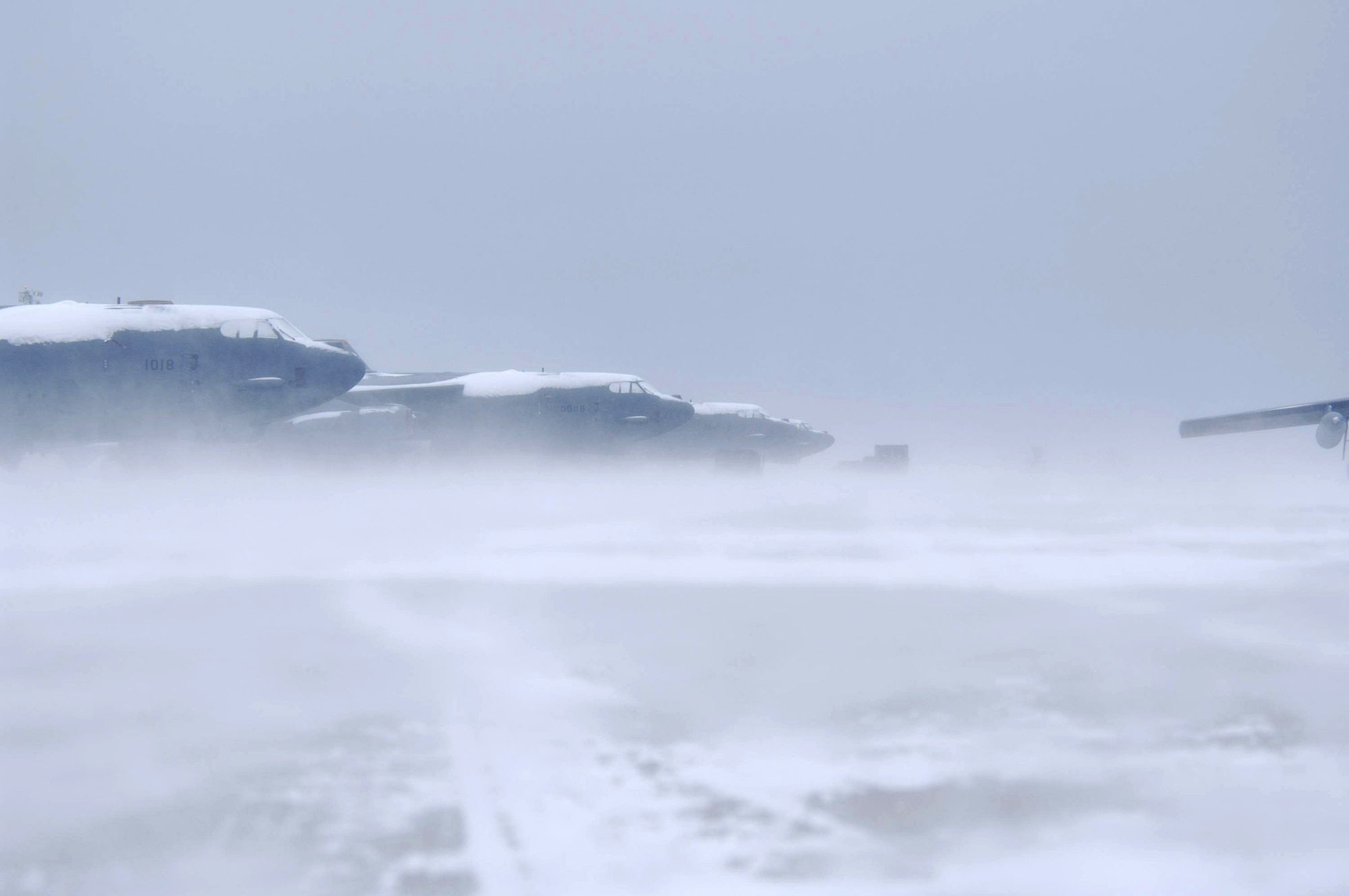 A group of B-52 Stratofortress sits on the flightline during low visibility Jan. 8 at Minot Air Force Base, N.D. The base experienced sub-zero temperatures and gusts of wind up to 50 mph. (U.S. Air Force photo/Airman 1st Class Christopher Boitz) 