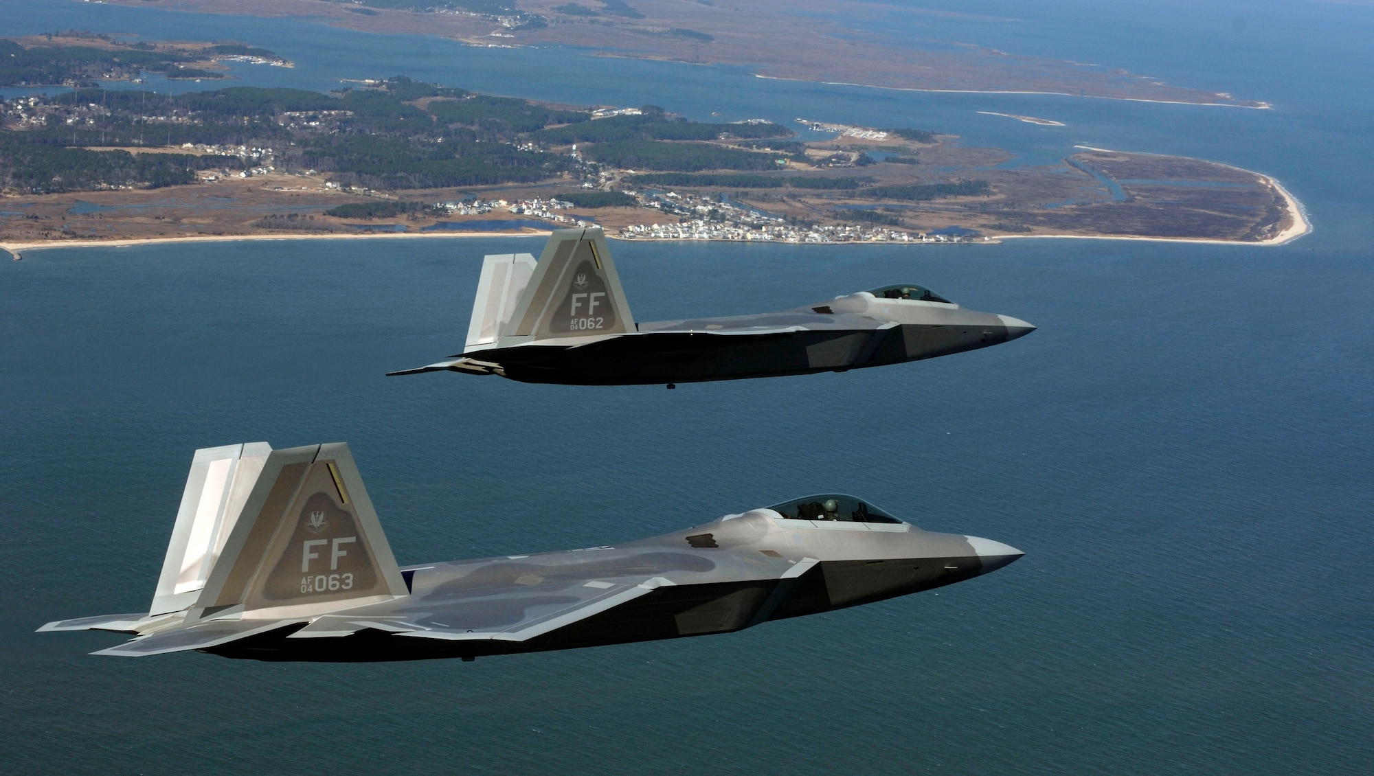 Two F-22 Raptors move into the Langley Air Force Base pattern over Virginia. A squadron of F-22 Raptors is scheduled to deploy to Kadena Air Base, Japan, as part of U.S. Pacific Command's Theater Security Package in the Western Pacific in early 2007. This will be the first overseas deployment for the Air Force's newest fighter. (U.S. Air Force photo/Tech. Sgt. Ben Bloker)  