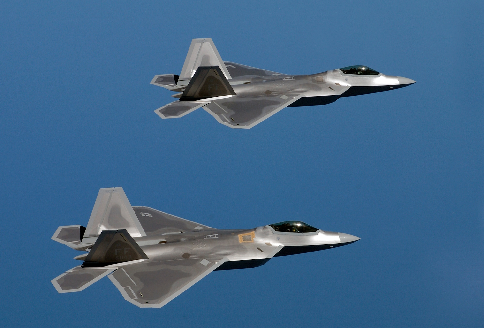 F-22 Raptors fly over Langley Air Force Base, Va. A squadron of F-22 Raptors is scheduled to deploy to Kadena Air Base, Japan, as part of U.S. Pacific Command's Theater Security Package in the Western Pacific in early 2007. This will be the first overseas deployment for the Air Force's newest fighter. (U.S. Air Force photo/Tech. Sgt. Ben Bloker)
