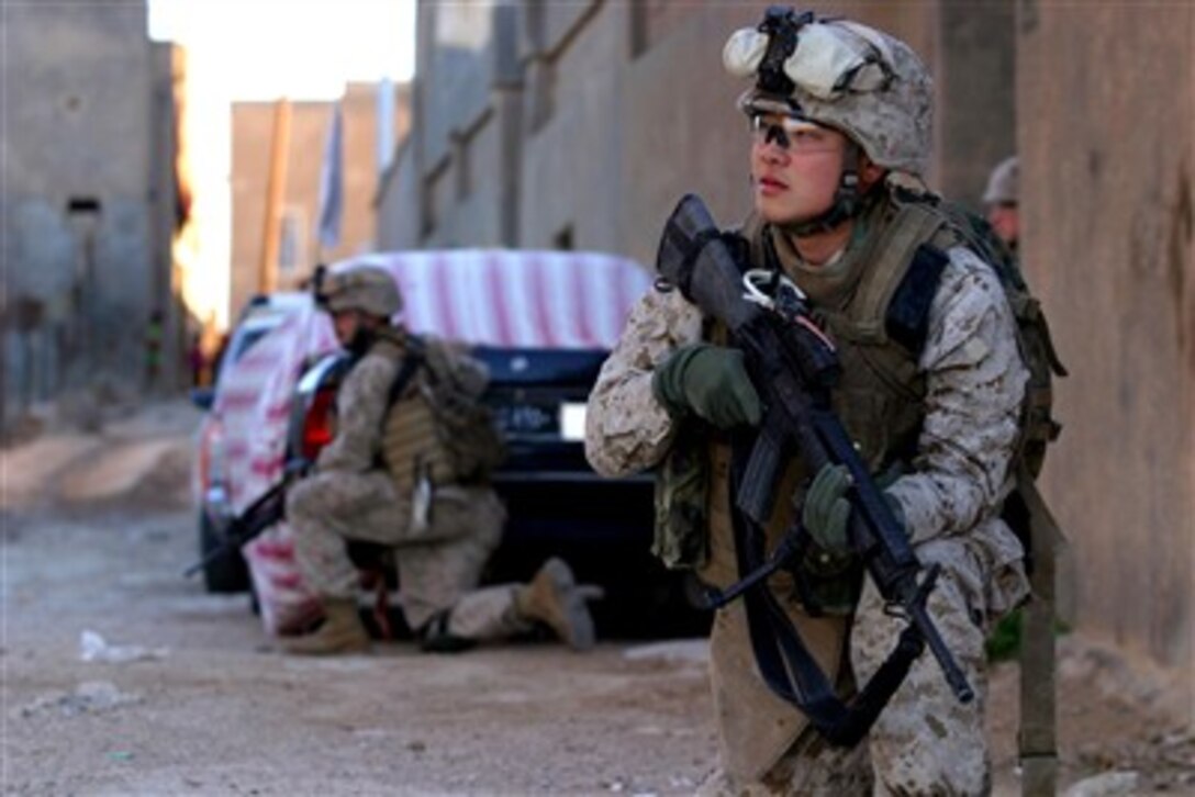 U.S. Marine Corps Lance Cpl. Ji H. Kim provides security during a patrol in Haqlaniyah, Iraq, on Dec. 19, 2006.  Kim is assigned to 2nd Battalion, 3rd Marine Regiment, Regimental Combat Team 7, I Marine Expeditionary Force (Forward).  