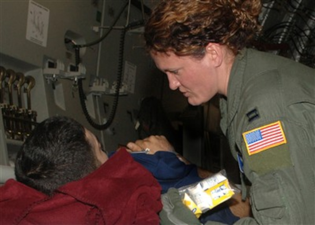 U.S. Air Force Capt. Carla Sutton (right) from the 86th Aeromedical Evacuation Squadron talks to a patient during the arrival of a flight coming from Southwest Asia into Ramstein Air Base, Germany, on Dec. 5, 2006.  