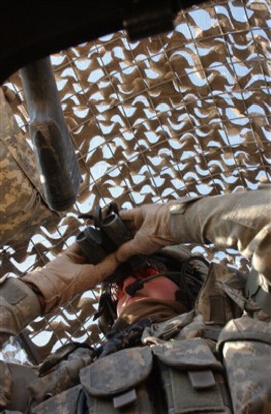 A U.S. Army gunner from 2nd Battalion, 5th Cavalry Regiment, 1st Brigade Combat Team, 1st Cavalry Division looks at his surroundings during a patrol near Kandari market in Baghdad, Iraq, on Dec. 30, 2006.  