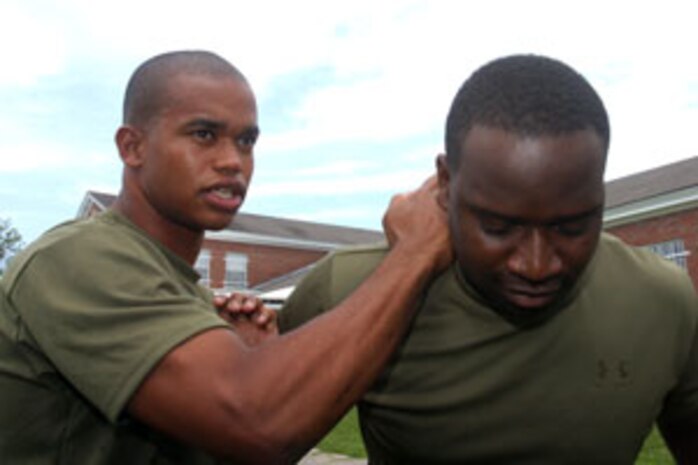 Cpl. Daniel Callaway, embark specialist, 24th Marine Expeditionary Unit, teaches Sgt. Vernard Fuller, police sergeant, 24th Marine Expeditionary Unit, proper technique to knee someone during a Marine Corps Martial Arts Program class here July 10. By staying active in physical fitness, the pursuit of knowledge, and spirituality; the 22-year-old believes he is living the right way of life.