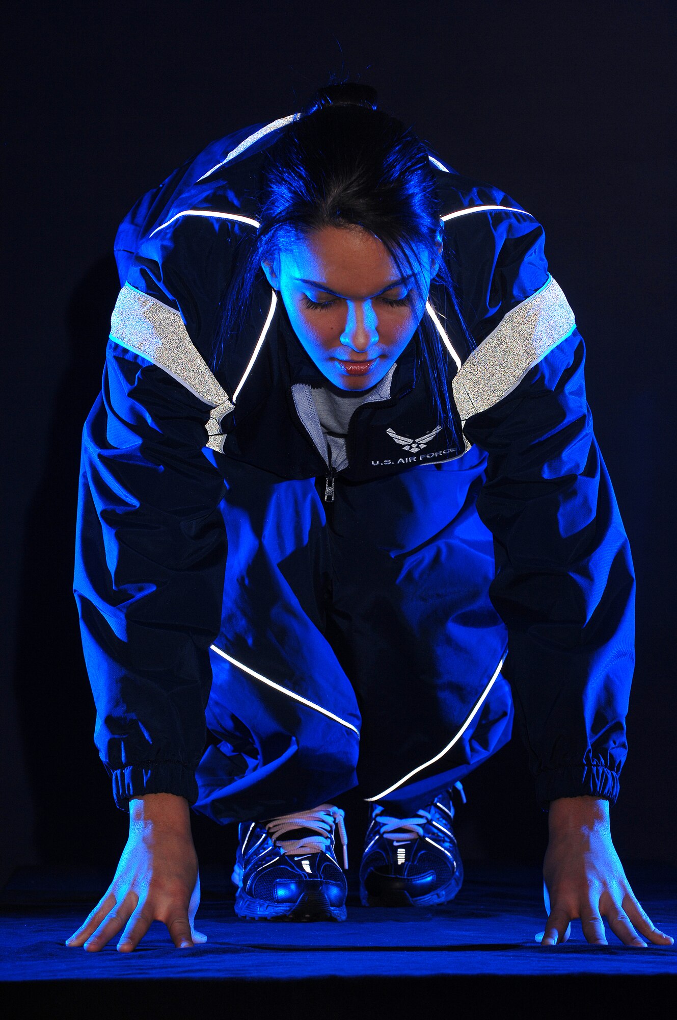 Airman 1st Class Savannah Orozco is photographed in her physical training uniform for a fitness poster Jan. 5 in the multimedia studio at McChord Air Force Base, Wash.  Airman Orozco is with the 62nd Operations Support Squadron there.   (U.S. Air Force photo/Abner Guzman) 