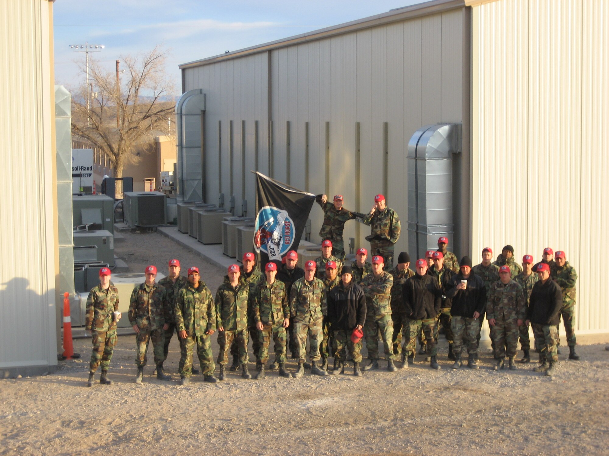  The multi-crafted team of REDHORSE Airmen pose for a group picture outside their recently constructed facilities for the 42nd Attack Squadron and 11th Reconnaissance Squadron at Creech. U.S. Air Force photo by Capt. Steve Thomas / 820th REDHORSE