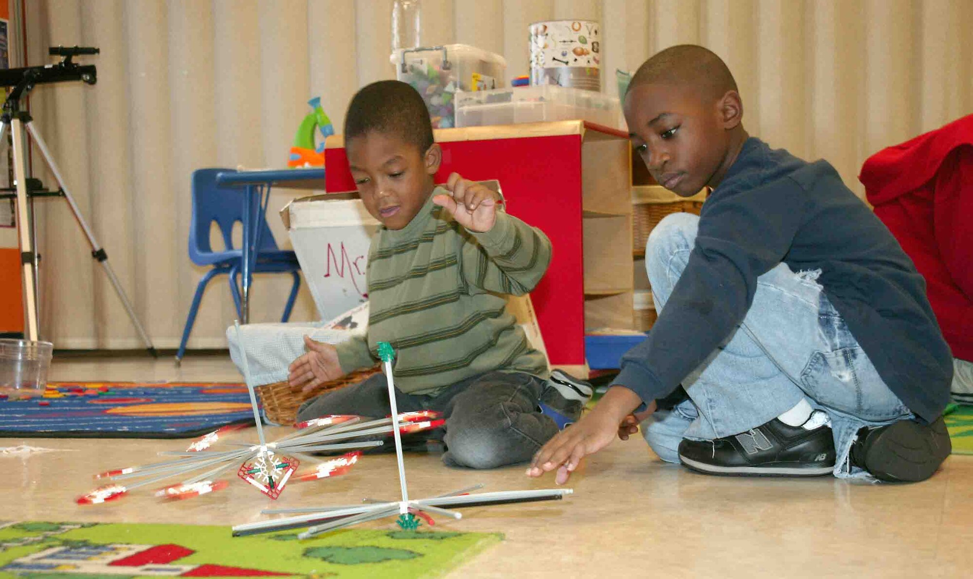 SHAW AIR FORCE BASE, S.C. -- Andrew (left), son of Tina and Tech. Sgt. James Selby, 609th Air Communications Squadron, and Devaughn, son of Angela and Army Sgt. 1st. Class Charlie Sanders, 4th Battlefield Coordination Detachment, perform  test runs on the spinning tops they built. (U.S. Air Force photo/Senior Airman John Gordinier