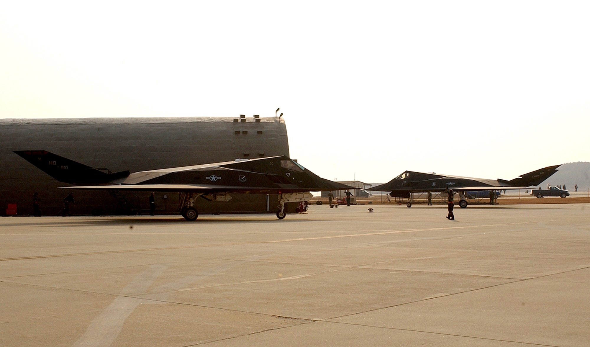 Senior Airman Jason Stanfield ushers in an F-117 Nighthawk after its arrival Jan. 11 to Kunsan Air Base, Republic of Korea. The aircraft, together with 300 Airmen, deployed here from Holloman Air Force Base, N.M., as part of a routine Air Expeditionary Force rotation. The aircraft, assigned to the 9th Expeditionary Fighter Squadron, is part of the third squadron of Kunsan AB's host unit, the 8th Fighter Wing, during the deployment's duration. Airman Stanfield is an F-117 crew chief. (U.S. Air Force photo/Senior Airman Darnell Cannady)