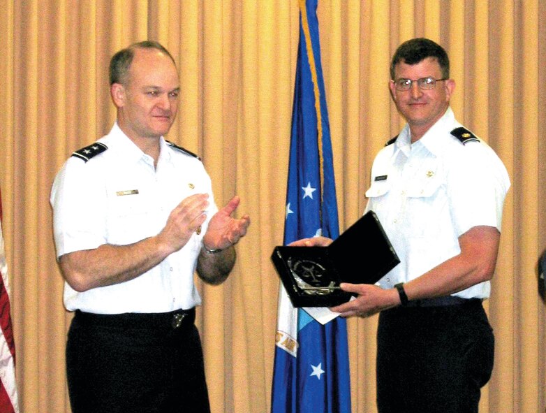(Courtesy photo) Maj Gen Jack Rives presents Major Boydston his 2003 Outstanding Reserve Judge Advocate award.