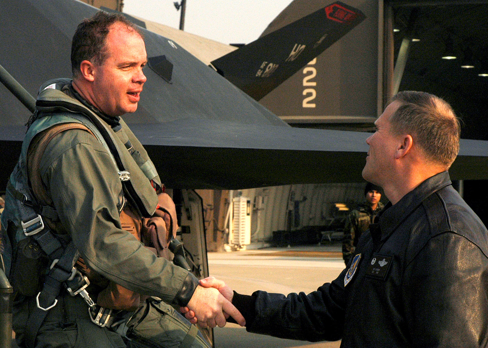 Col. Jeff Lofgren (right) greets Maj. Ronald Keller after landing Jan. 11 at Kunsan Air Base, Korea. Major Keller, an F-117 Nighthawk pilot, is part of a more than 300-person deployment to Kunsan from Holloman Air Force Base, N.M. Assigned to the 9th Expeditionary Fighter Squadron, the Holloman AFB Airmen are fulfilling an Air Expeditionary Force rotation to the Republic of Korea. The AEF deployment, according to Kunsan AB officials, "demonstrates the continued U.S. commitment to fulfill its security responsibilities throughout the Western Pacific." Colonel Lofgren is the 8th Fighter Wing commander. (U.S. Air Force photo/Senior Airman Stephen Collier)
                     