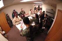 MINOT AIR FORCE BASE, N.D. -- Airmen deploying go through a pre-deployment flight line inside Dock 9 here Jan. 10. The PDF line is one of the Airmen's last chances to see various agencies, such as the legal office and the base chaplain, from the base before leaving on a deployment. Fifty-six of Minot’s Airmen will be making the journey to a forward deployed location. (U.S. Air Force photo by Airman 1st Class Christopher Boitz)