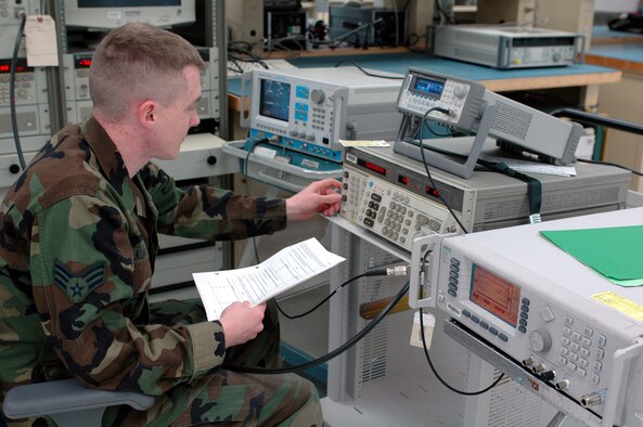 Senior Airman Scott Kunkel, Precision Measurement Equipment Laboratory journeyman, calibrates a communication system analyzer. The PMEL technicians rotate through three different sections, physical dimensional, wave-form analysis and electrical standards, in order to maintain their training gained through their 9-month technical training at Keesler Air Force Base, Miss. (U.S. Air Force photo by 1st Lt. Lindsey Hahn)