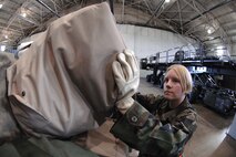 MINOT AIR FORCE BASE, N.D. -- Airman 1st Class Ashley Carothers, 5th Logistics Readiness Squadron, loads deployment bags onto a pallet inside Dock here before leaving for a deployment Jan. 10. Approximately 120 bags were loaded, totaling up to 5,800 pounds for this deployment. Fifty-six of Minot’s Airmen will be making the journey to a forward deployed location. (U.S. Air Force photo by Airman 1st Class Christopher Boitz)