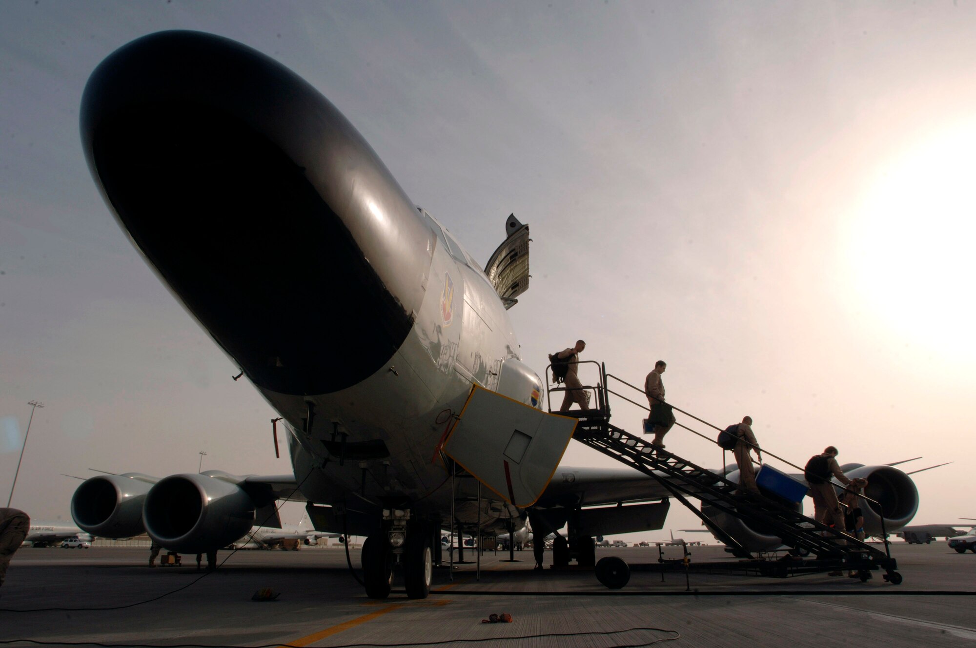 Shortly after an RC-135 Rivet Joint returns to it's desert base in the Persian Gulf following a mission over Iraq, the first of 34 crew members begin to exit the aircraft. The aircraft, deployed from the 55th Wing at Offutt Air Force Base, Neb., has maintained a constant presence in Southwest Asia for 6,000 days since Aug. 9, 1990, just prior to Operation Desert Shield. (U.S. Air Force photo/Master Sgt. Scott Wagers)
