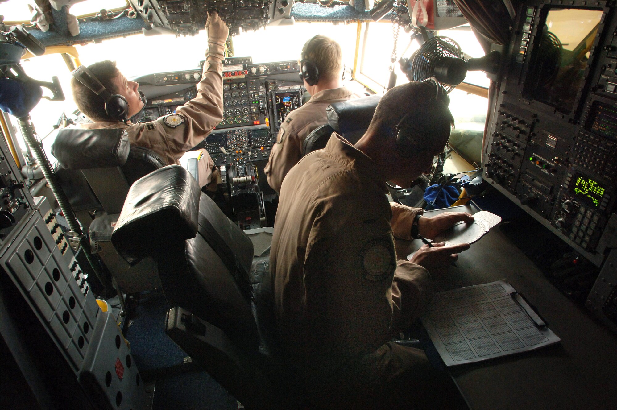 Captains Guy Perrow and Erik Dunkley and 1st Lt. Michael Morrison prep a RC-135 Rivet Joint for a flight. RC-135's have been deployed from the 55th Wing at Offutt Air Force Base, Neb., and maintained a constant presence in Southwest Asia for 6,000 days since Aug. 9, 1990, just prior to Operation Desert Shield. Captain Perrow is the aircraft commander, Captain Dunkley is the co-pilot, and Lieutenant Morrison is the navigator. (U.S. Air Force photo/Master Sgt. Scott Wagers)