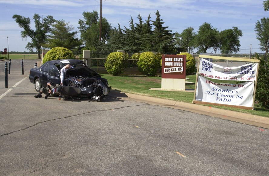 (Photo by SrA Amanda Mills) A wrecked car and motorcycle remind people leaving Vance Air Force Base of the importance of seat belts and not drinking and driving. 
The display, sponsored by Stanley’s of Enid, the 71st Communications Squadron and Vance Against Drunk Driving, runs until after the holiday.