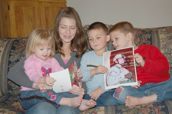 Virginia Neubert reads a card from her deployed husband to their children. Virginia is one of many spouses of deployed military members who deal with the day to day stresses of being left alone.