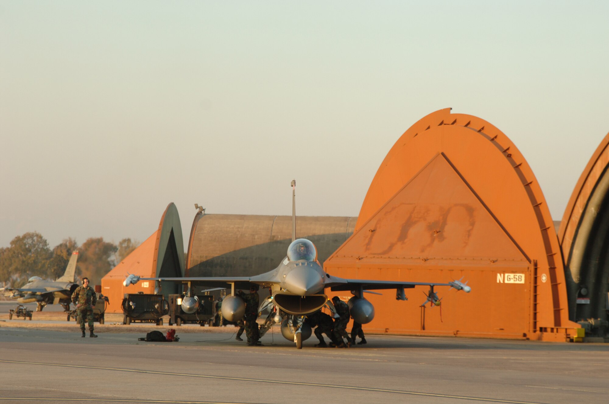 Maintainers from the 52nd Aircraft Maintenance Squadron recover a F-16CJ Fighting Falcon aircraft after it landed here Jan. 8. The 22nd Fighter Squadron deployed here as part of a rotational squadron deployment. (U.S. Air Force Photo by Airman 1st Class Kelly LeGuillion)