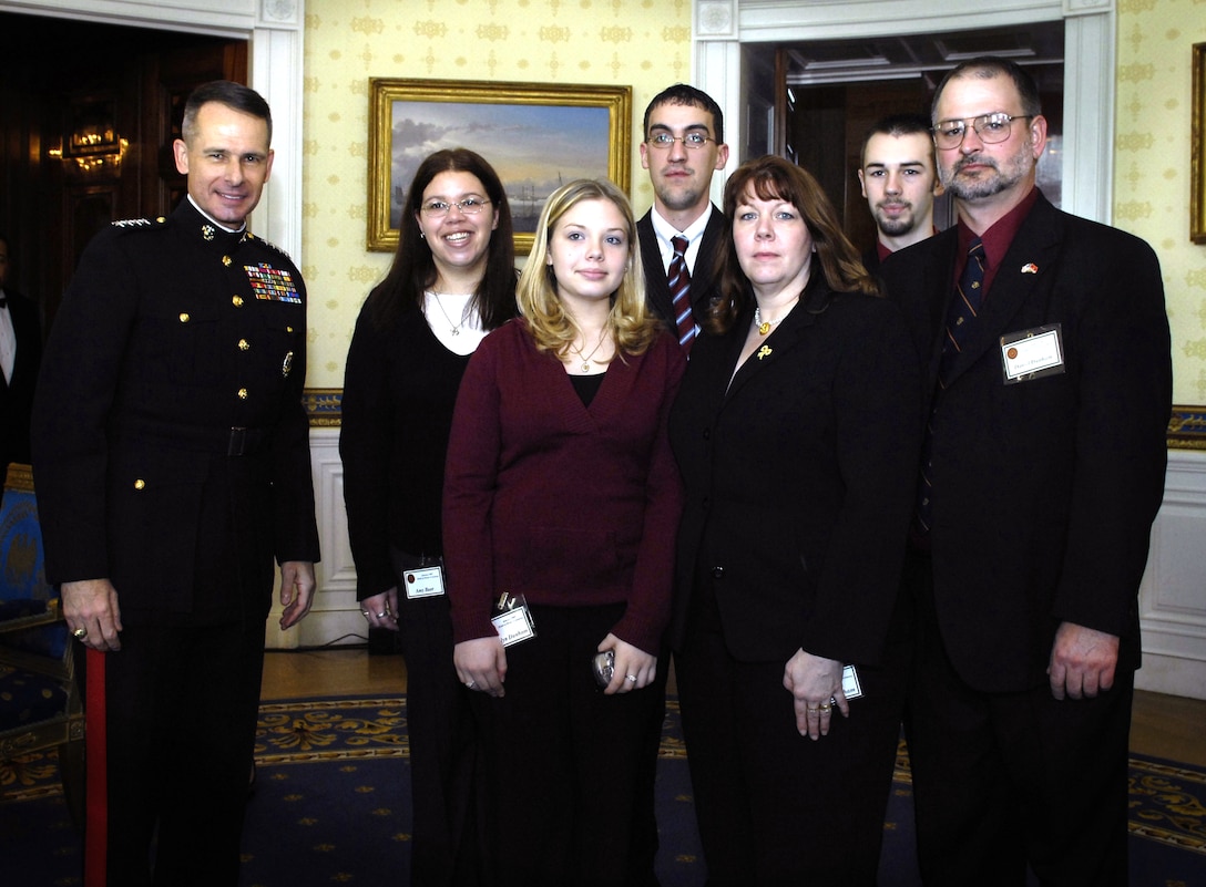 U.S. Marine Gen. Peter Pace, left, takes a photo with the Dunham family prior to the start of a Medal of Honor ceremony for their son and brother, U.S. Marine Cpl. Jason Dunham, during a ceremony in his honor at the White House, Jan. 11, 2007.  Dunham gave his own life in April 2004 so that the men under his command might live.