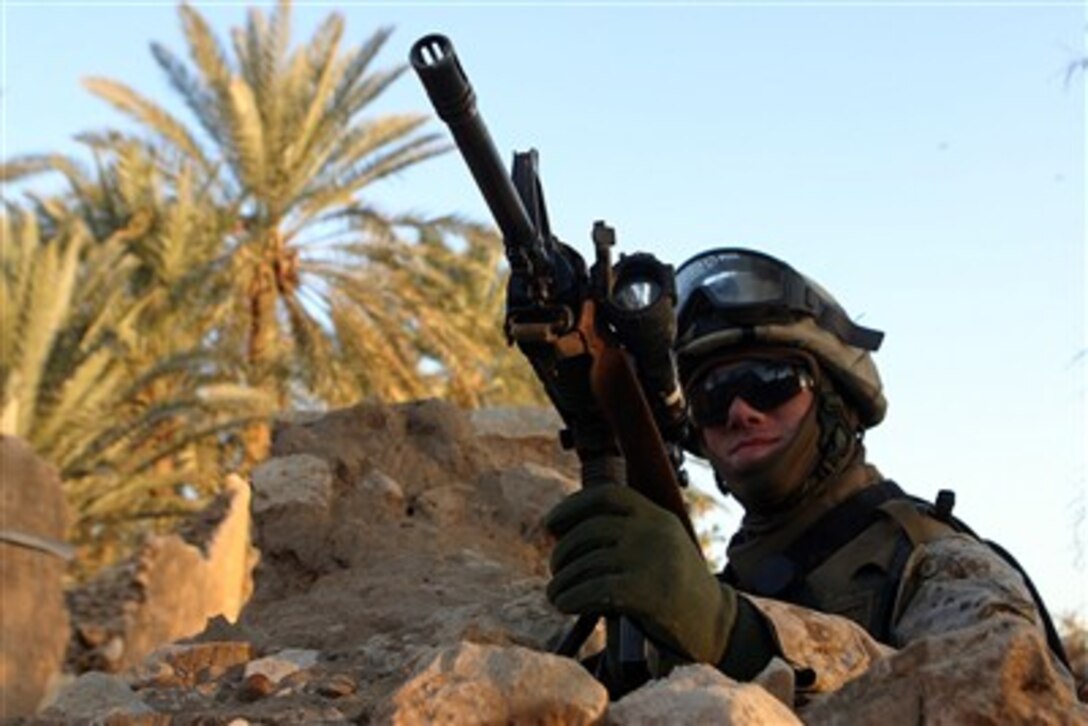 U.S. Marine Corps Lance Cpl. Nicholas Darrah provides security while fellow Marines conduct cordon and search operations looking for weapons and explosives in Haditha, Iraq, on Dec. 21, 2006.  Darrah is assigned as a rifleman with 1st Squad, Golf Company, Battalion Landing Team, 2nd Battalion, 4th Marine Regiment.  