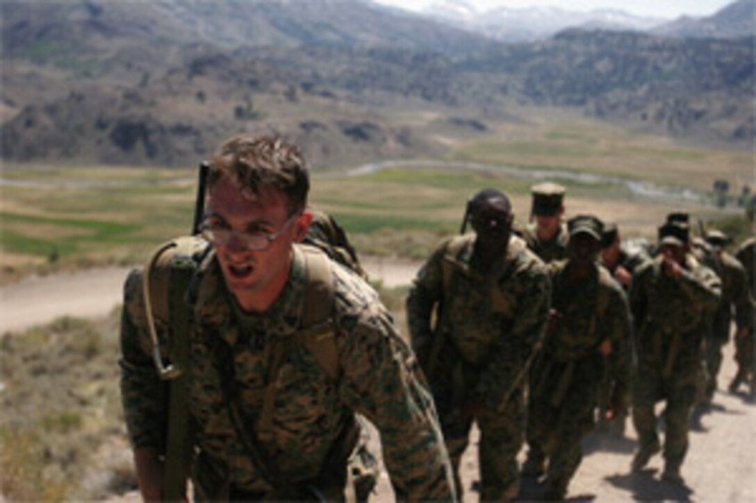 Cpl. Daniel C. Buck, a supply clerk with Headquarters and Support Battalion experiences the physical and mental standards of MLC while hiking up Heart Attack Hill.