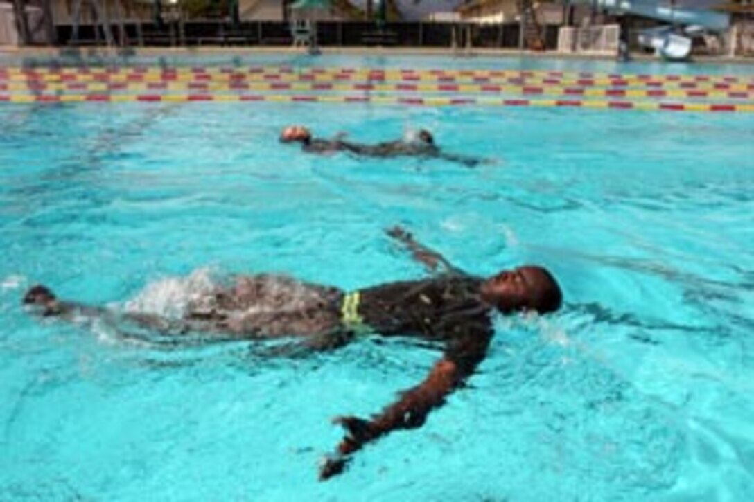 Staff Sgt. Kendrick McRae, Supply Company,  passes another competitor during the 200-meter swim.