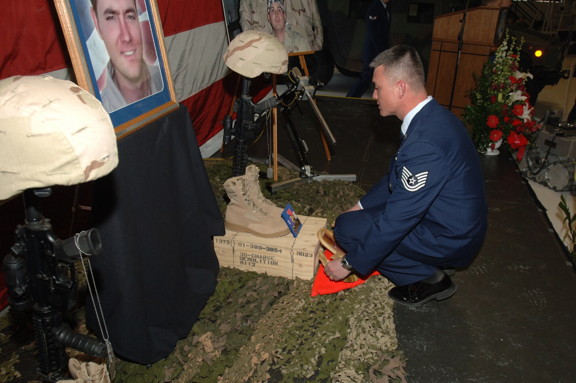 Tech. Sgt. Robert Hood puts finishing touches Jan. 12 on a memorial display honoring three Hill Airmen who were killed in Iraq Jan. 7. Sergeant Hood is assigned to the 775th Civil Engineer Squadron Explosive Ordnance Disposal Flight at Hill Air Force Base, Utah. (U.S. Air Force photo/Alex R. Lloyd)