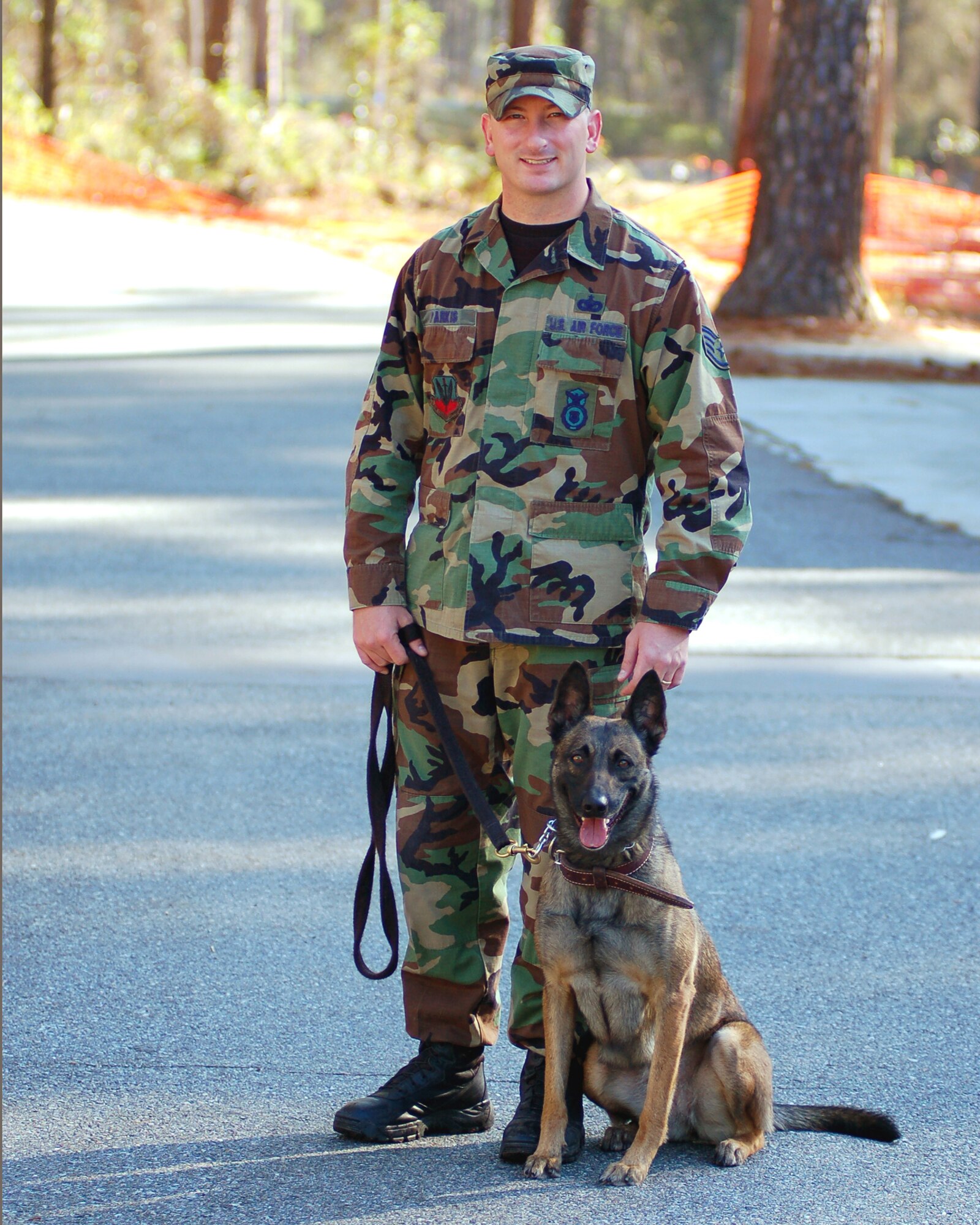 Staff Sgt. James Parkis and his military working dog, Ffifteen, take a break after agility training Dec. 28, 2006. Sergeant Parkis and Ffifteen are assigned to the 824th Security Forces Squadron, Moody AFB, Ga. (U.S. Air Force photo by Tech. Sgt. Parker Gyokeres)