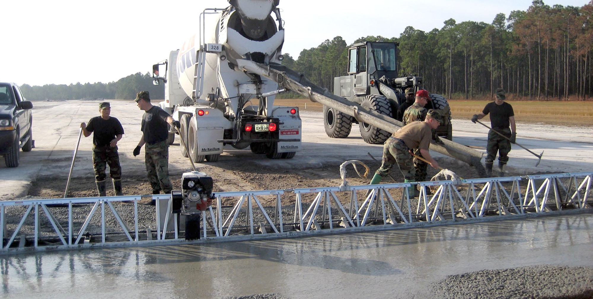 Members of the 341st Civil Engineer Squadron work together to spread concrete and repair a damaged runway during one of the exercise scenarios at Silver Flag. 
