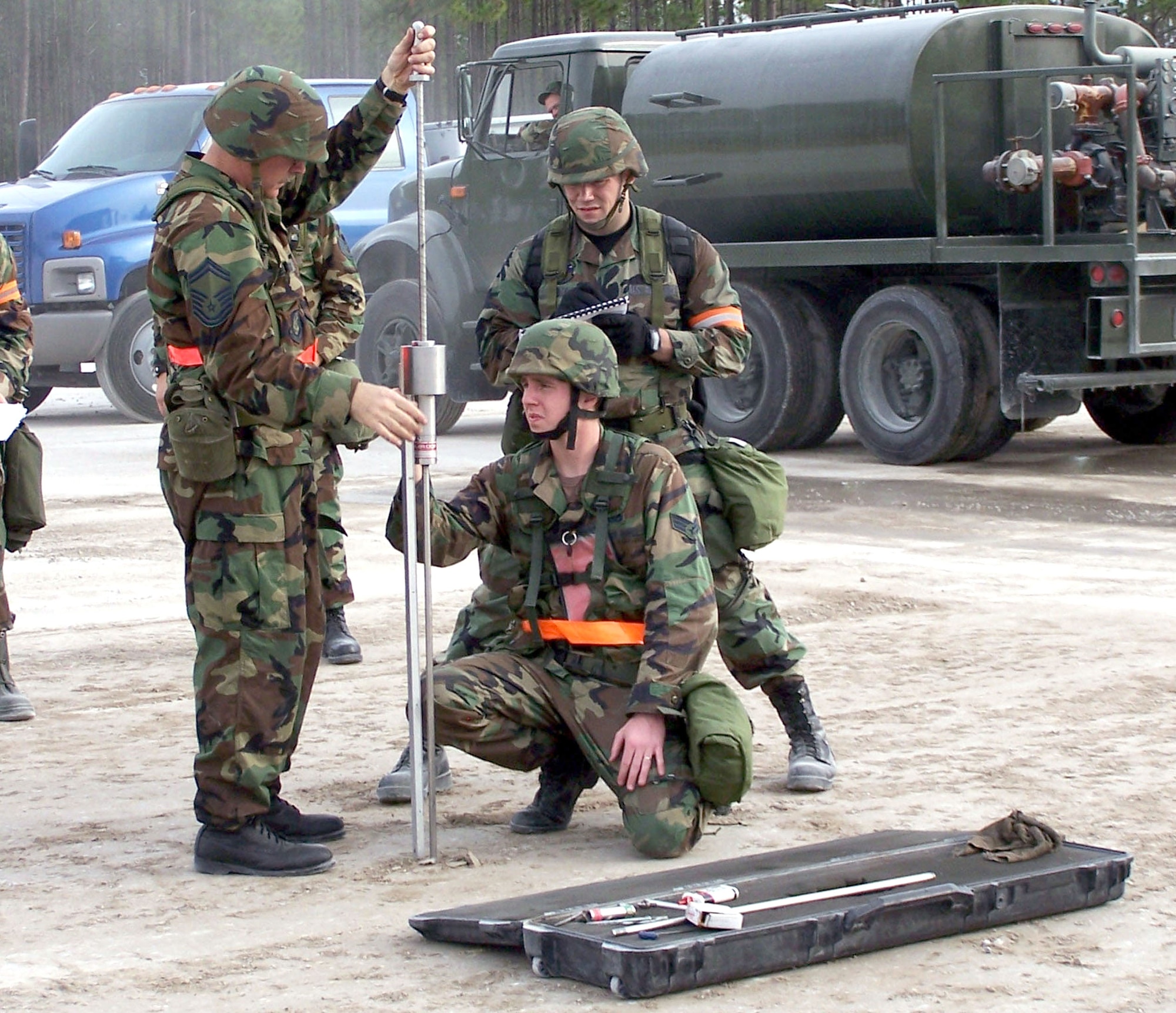 1st Lt. Chris White observes the teamwork of Senior Airman Troy Espenshade, 341st Civil Engineer Squadron and a member of the Pease Air National Guard who were testing the soil strength before installing a Mobile Aircraft Arresting System during Silver Flag.