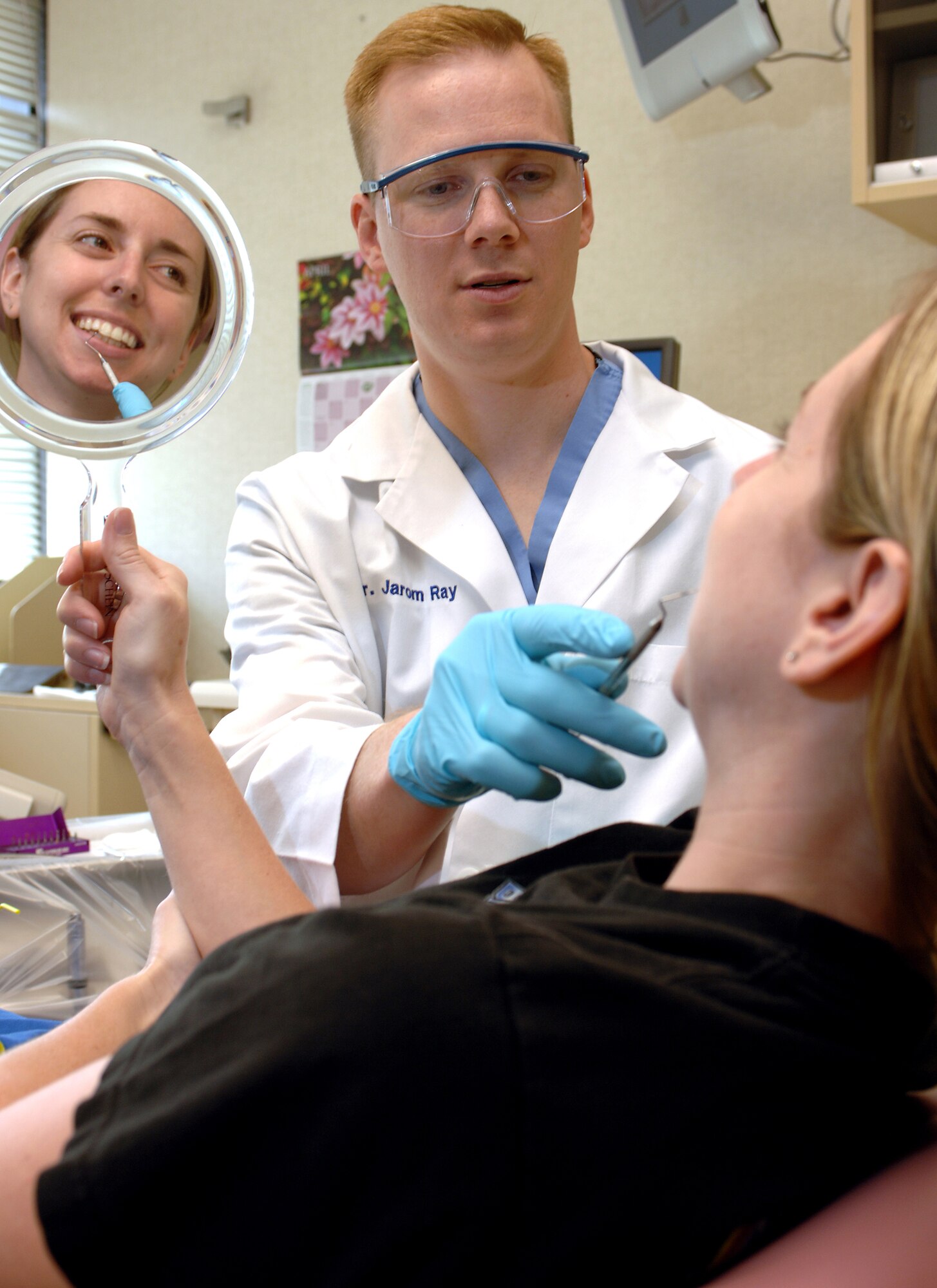 Capt. (Dr.) Jarom Ray discusses a dental procedure with a patient. Medical is one of several "hot" commissioned career fields for which the Air Force seeks qualified college graduates. Captain Ray is with the 437th Medical Group at Charleston Air Force Base, S.C. (U.S. Air Force photo/Master Sgt. Scott Reed)