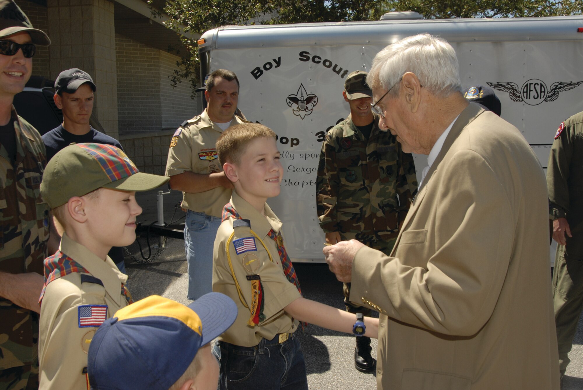 Kurt Anderson (center) shakes hands with retired Chief  Master Sgt. of the Air Force Airey after he presented the chief with a Pack 388 appreciation coin. Chief Airey mentored the Boy Scouts during a visit Sept. 21, 2006.  
