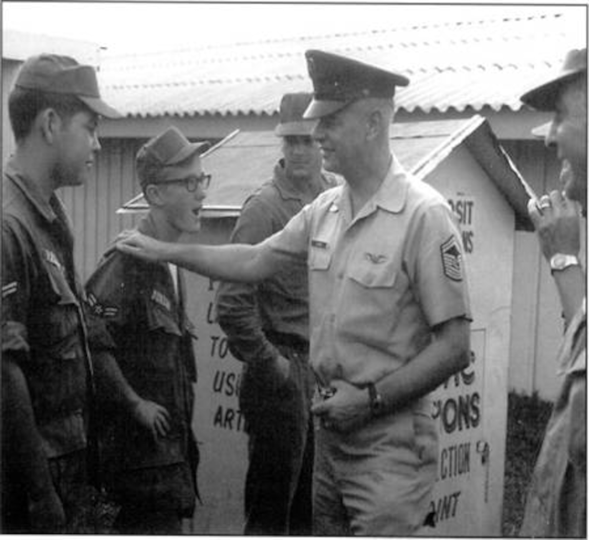 Chief Master Sgt. of the AIr Force Airey talks to Airmen 1st Class Tim Vasques and Ray Dunbar Jr. during his visit to Pleiku Air Base, Vietnam, in 1967.  