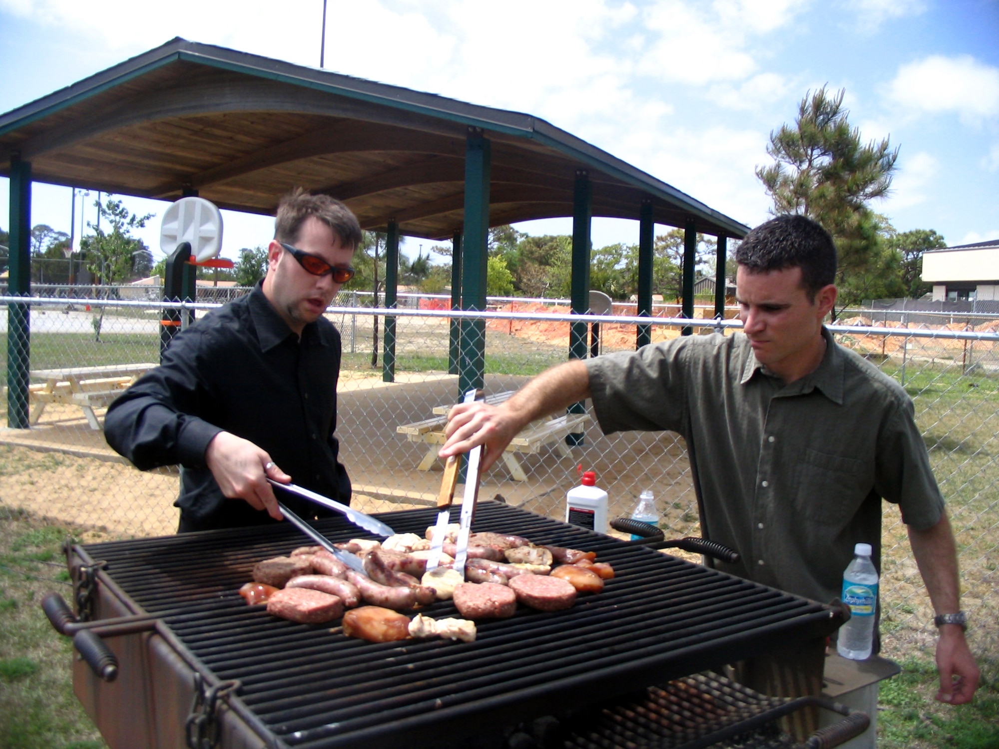 Members from the singles service man the grill after service. The Hurlburt Field Chapel singles group participates in a variety of events. (Courtesy Photographs)