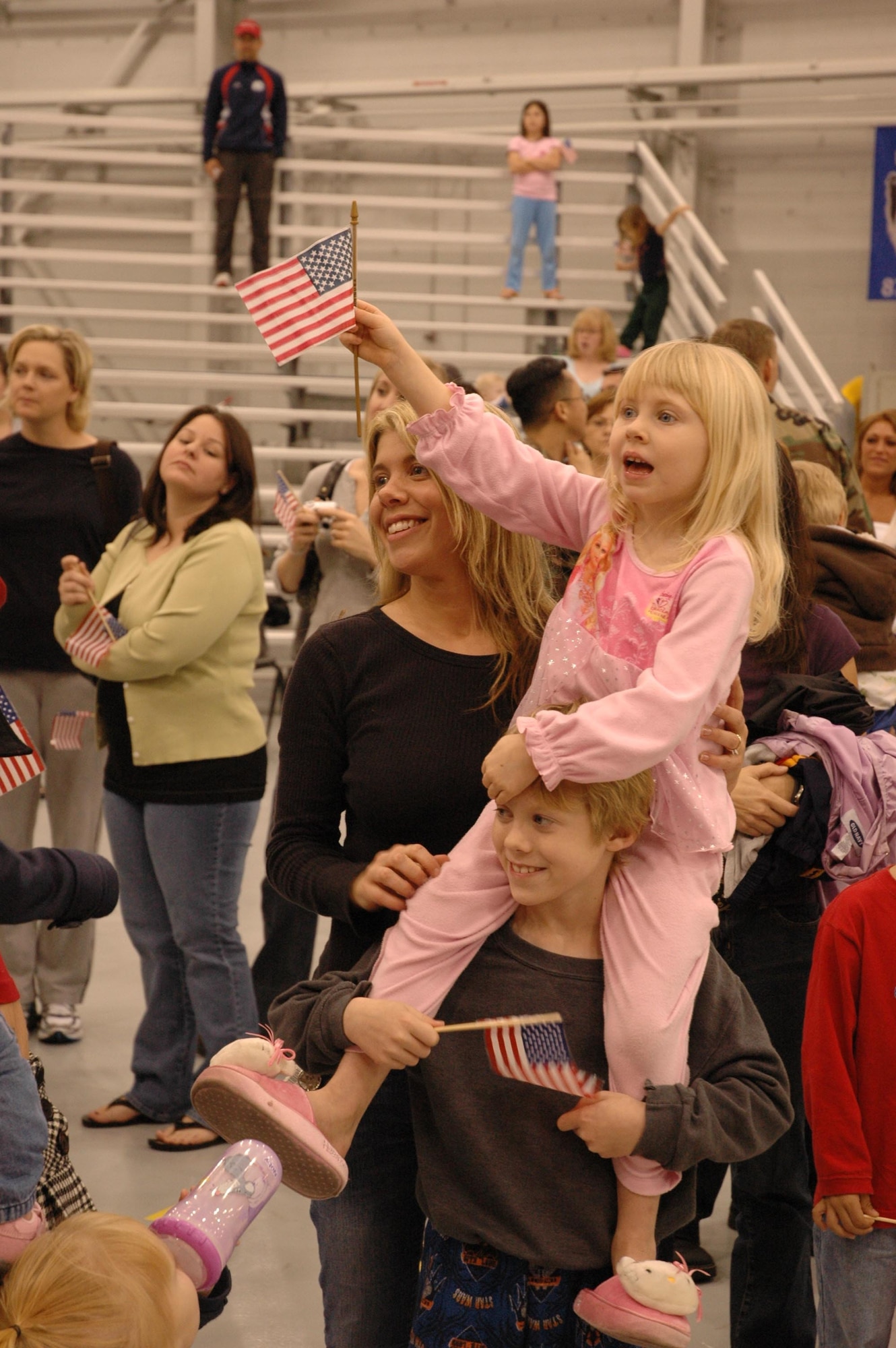 A family waits anxiously in Commando Hangar for the rotator plane from Southwest Asia, which arrived early Monday morning during Operation Homecoming. (U.S. Air Force Photograph by 1st Lt. Amy Cooper)