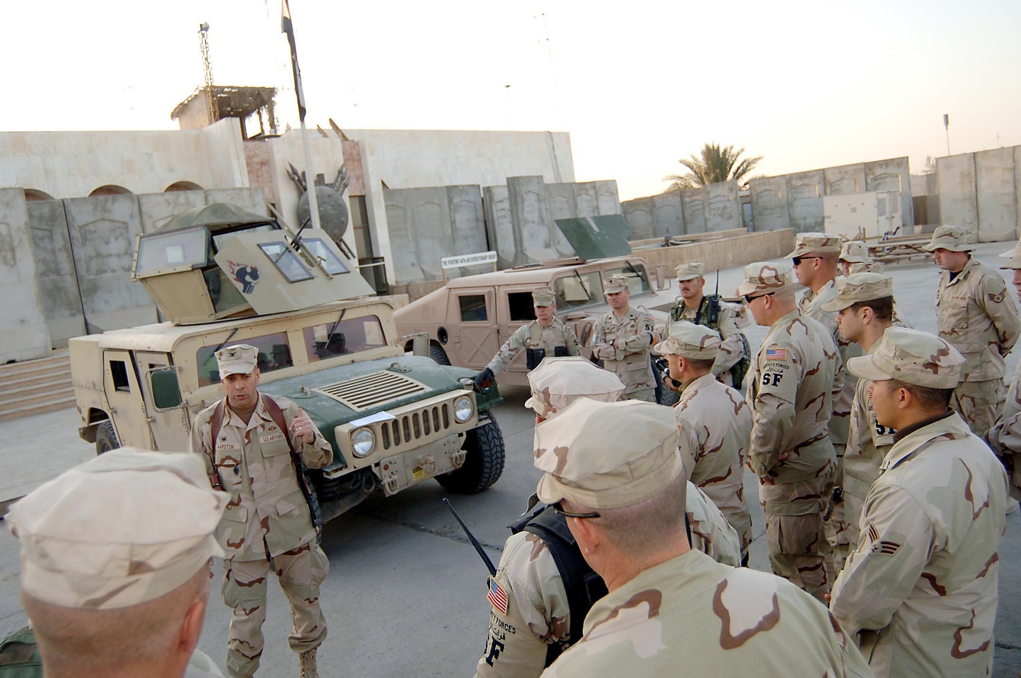 Col. Gregory Marston, 447th Air Expeditionary Group, commander, talks to security forces and logistics readiness Airmen after the first vehicle equipped with a Chavis Turret was handed over to security forces for testing. (U.S. Air Force Photograph by Staff Sgt. Scott McNabb)