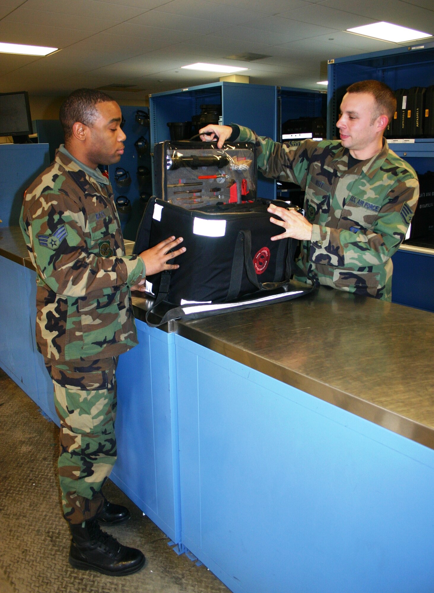 Staff Sgt. Ellwood Witt, 305th AMXS CTK technician, assists Senior Airman Rickorey Bates, 305th AMXS crew chief, in returning his tools for the day at the CTK here. The CTK process has recently been improved to make it more efficient for the technicians and customers. U.S. Air Force photo by Airman Rebekah Phy
