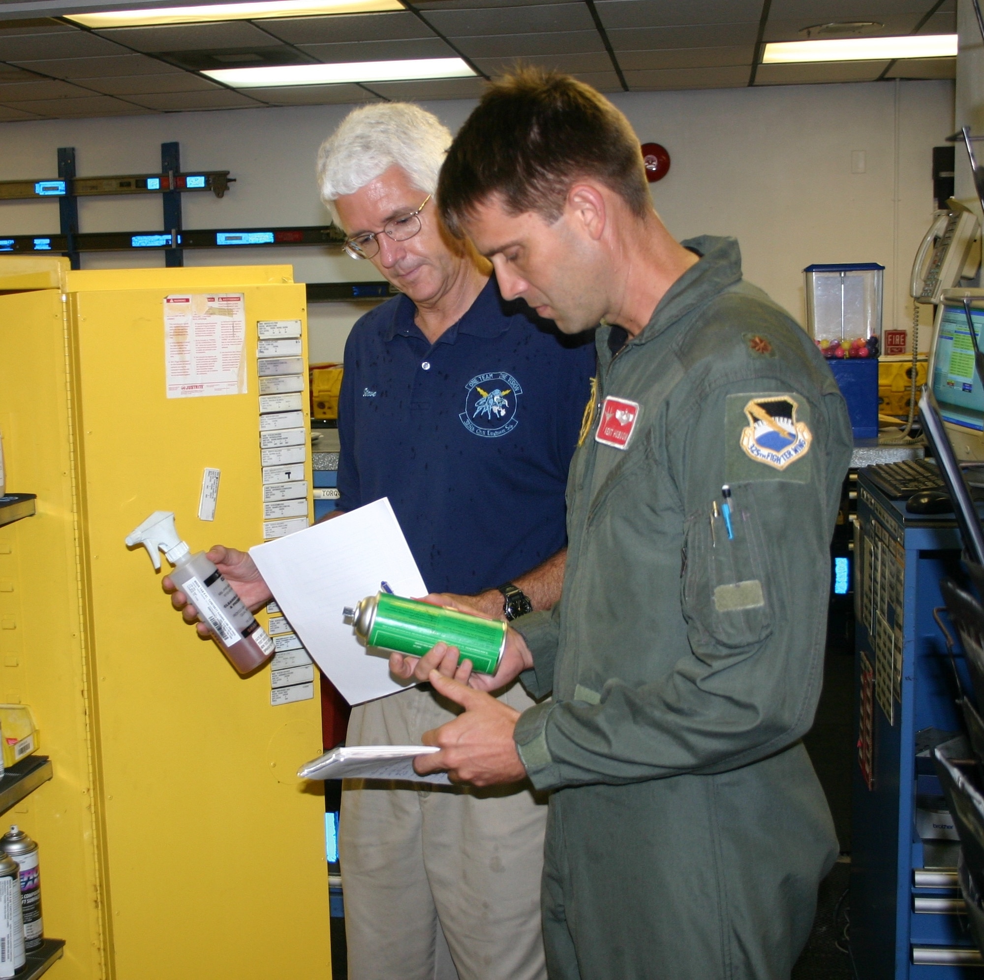 Maj. Kent Hobson, 95th Fighter Squadron pilot and Steve McLellan inspect a unit’s hazardous materials locker for compliance with Air Force and regulatory agency labeling, storage and safety requirements.