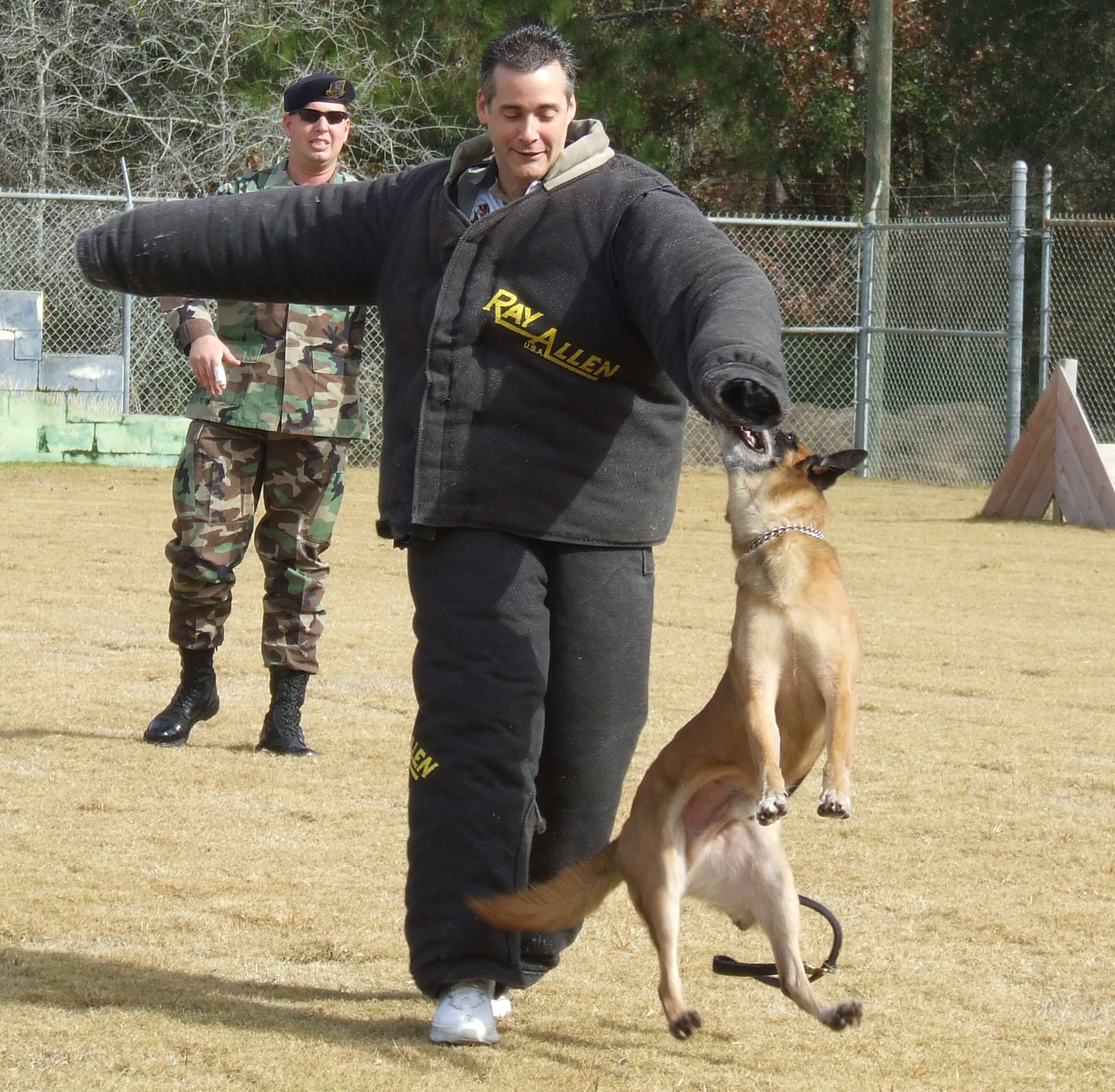 The 16th Electronic Warfare Squadron’s honorary commander Chip Totten shows off his new K-9 handbag during a military working dog demonstration at Tyndall AFB, Fla.,  Dec. 12.  
Mr. Totten accompanied Lt. Col. Mark Colbert, 16th EWS commander, to the 16th’s operating location located at Tyndall.  
“Chip insisted that he get bit by a dog during his tour as an honorary … and he certainly did,” said Colonel Colbert.  (U.S. Air Force Photo)