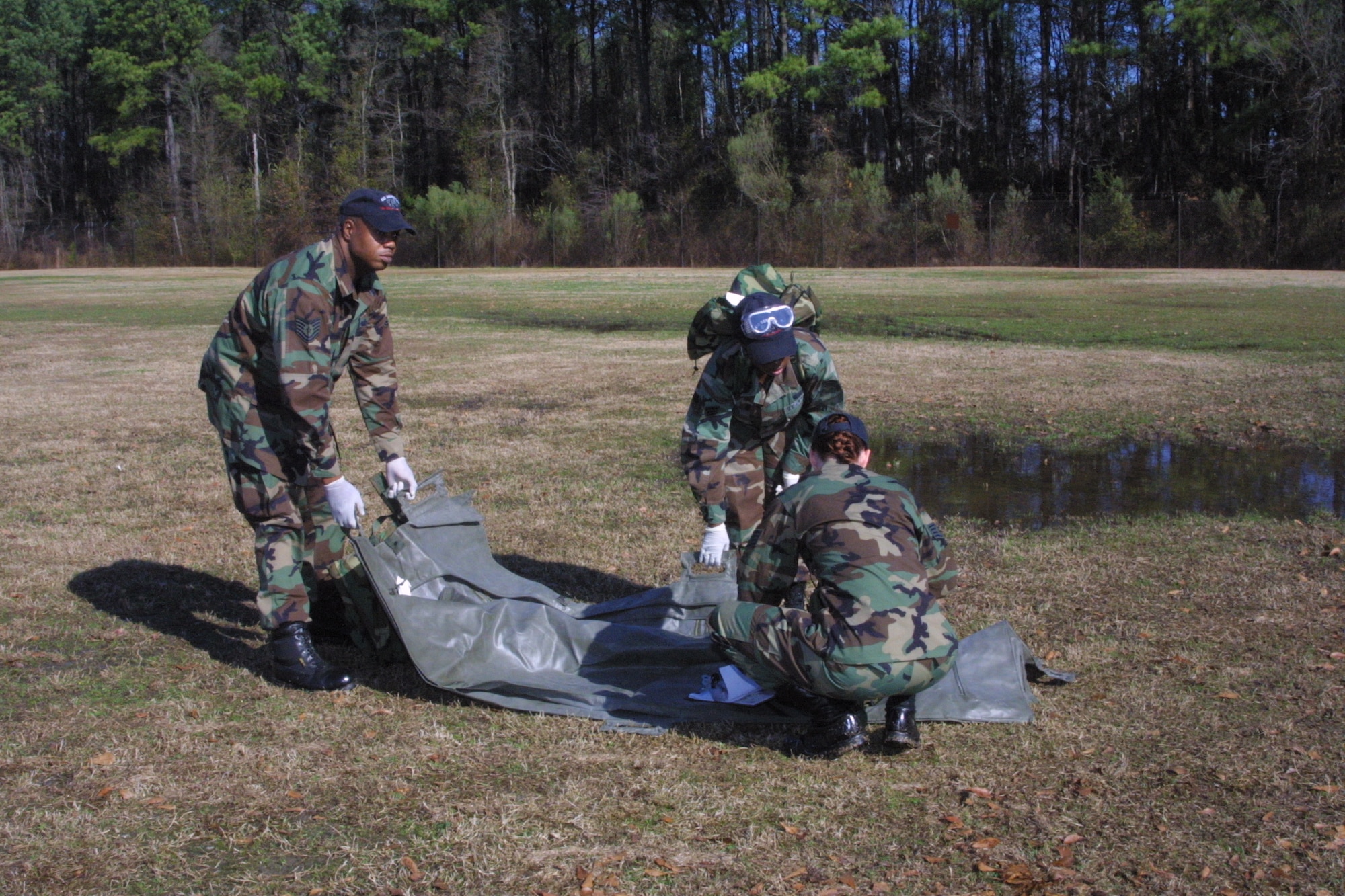 Search and Recovery Team members walk abreast and scan the ground around them after each step as they search for anything that could be remains or personal effects.